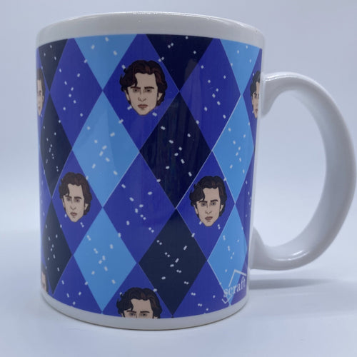 ceramic mug with argyle pattern in shades of blue. Timothee Chalamet's face is in the center of the diamonds.